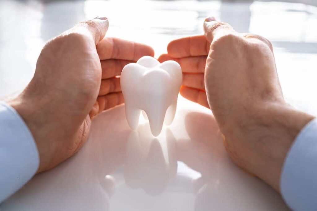 hands protecting tooth